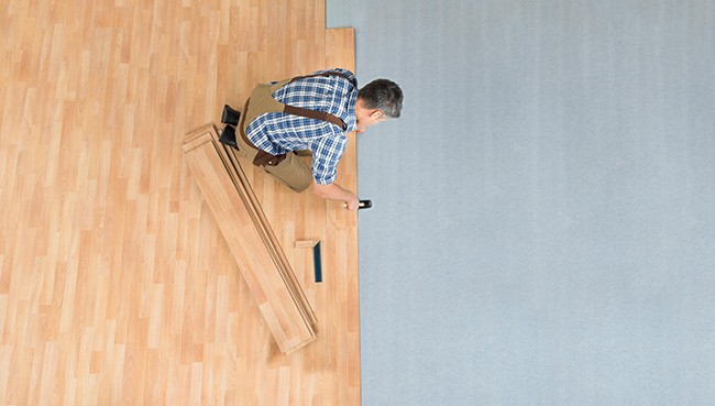 Worker Assembling New Laminate Floor | Havertown Carpet